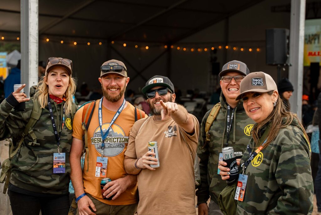 A group of people celebrating the Happy Hour festivities at Overland Expo